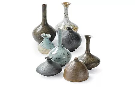 Eight eclectic stoneware vases in different shapes and sizes.